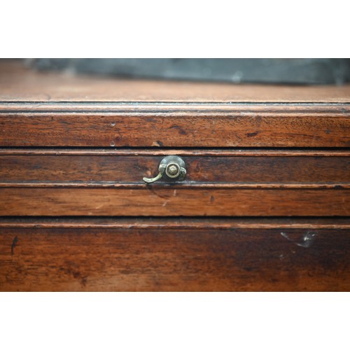 101 - A George III mahogany chest of three long graduating drawers below brush slide, raised on shaped bra... 