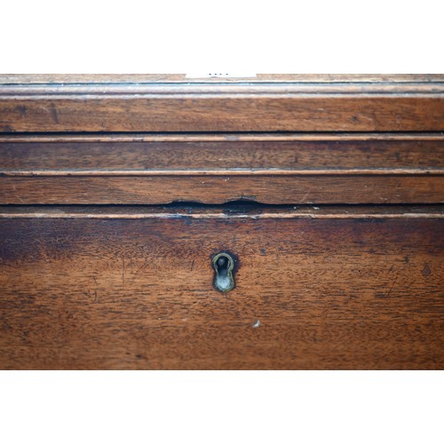 101 - A George III mahogany chest of three long graduating drawers below brush slide, raised on shaped bra... 