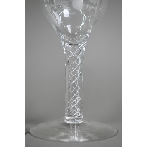 12 - A cordial glass with round funnel bowl on air twist baluster stem and conical foot, 16 cm, to/w a wi... 