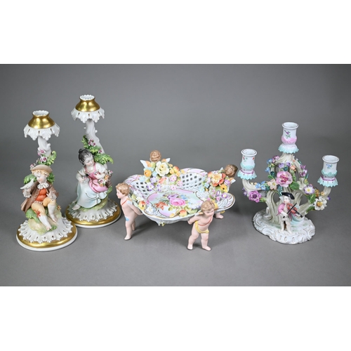 16 - A Continental porcelain floral-encrusted candelabrum with three sconces and dancing cherubs playing ... 