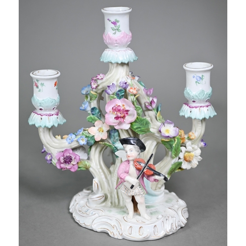 16 - A Continental porcelain floral-encrusted candelabrum with three sconces and dancing cherubs playing ... 