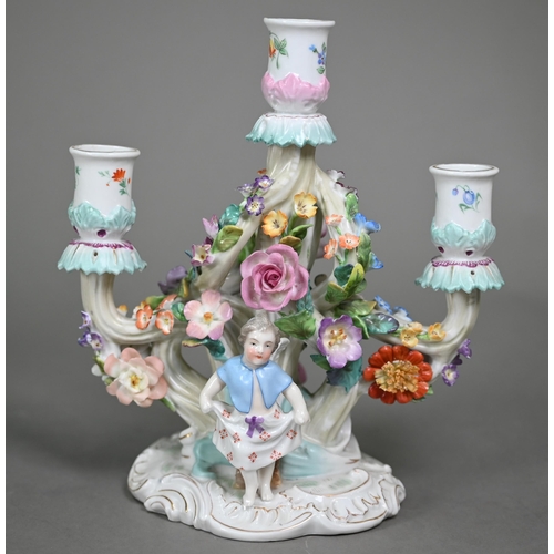 16 - A Continental porcelain floral-encrusted candelabrum with three sconces and dancing cherubs playing ... 