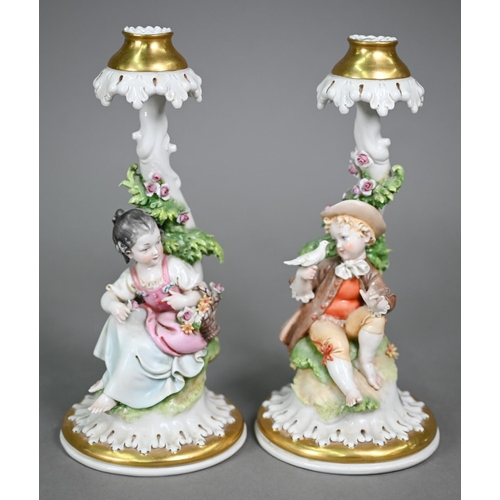 16 - A Continental porcelain floral-encrusted candelabrum with three sconces and dancing cherubs playing ... 