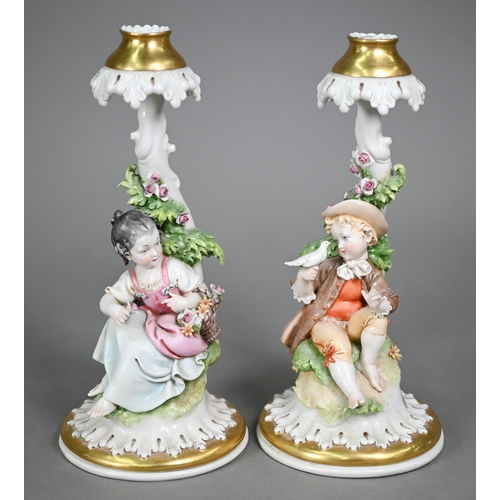 16 - A Continental porcelain floral-encrusted candelabrum with three sconces and dancing cherubs playing ... 