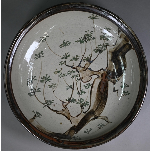 28 - John Bedding (St. Ives): a brown-glazed large bowl, painted with trees in his typical Japanese manne... 