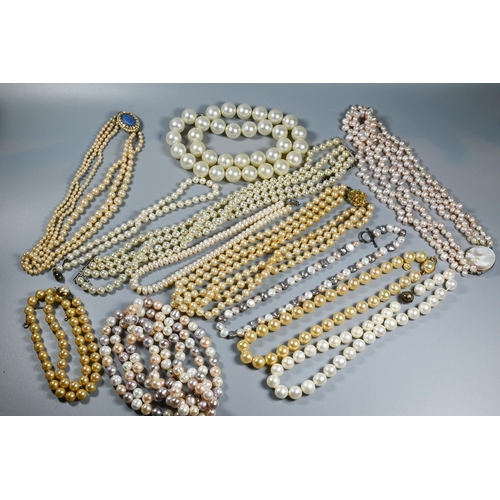 385 - A collection of cultured and simulated pearl necklaces, including pale pink, baroque, chokers, opera... 