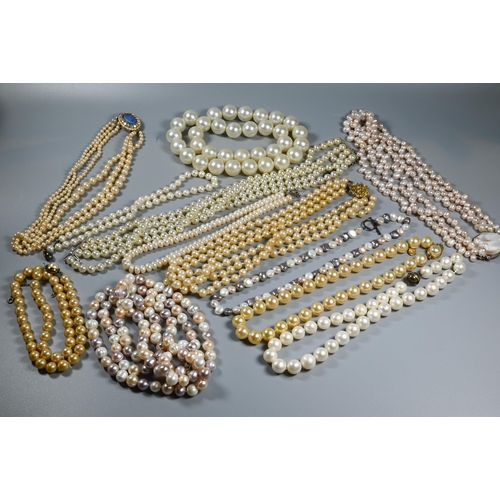 385 - A collection of cultured and simulated pearl necklaces, including pale pink, baroque, chokers, opera... 