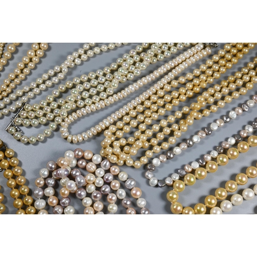 385 - A collection of cultured and simulated pearl necklaces, including pale pink, baroque, chokers, opera... 