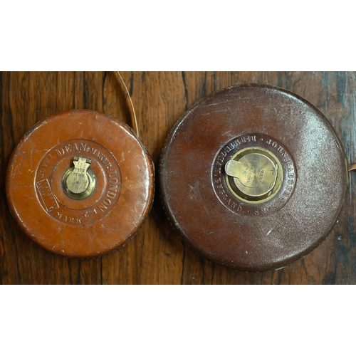 114 - Two vintage leather-cased measuring tapes - 100ft/66ft, to/w two brass-mounted wood spirit levels (4... 