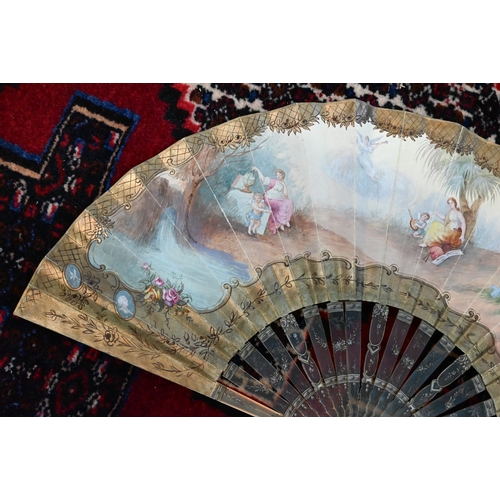 115 - An antique fan, the paper leaf painted in watercolour with Muses, on painted tortoiseshell (probably... 