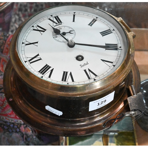 129 - A lacquered brass Sestrel ship's clock with 14 cm enamel dial