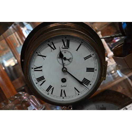 129 - A lacquered brass Sestrel ship's clock with 14 cm enamel dial