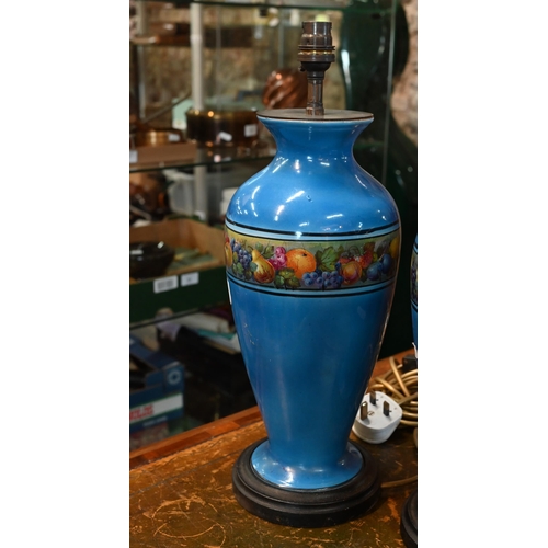 132 - AMENDED ESTIMATE A pair of blue-glazed ceramic table lamps printed with bands of fruit, 43 cm high o... 