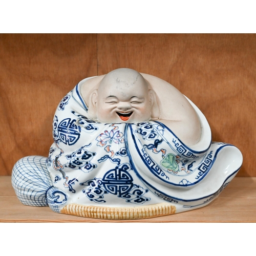 27 - A Chinese part glazed porcelain laughing Buddha, 22 x 37 cm