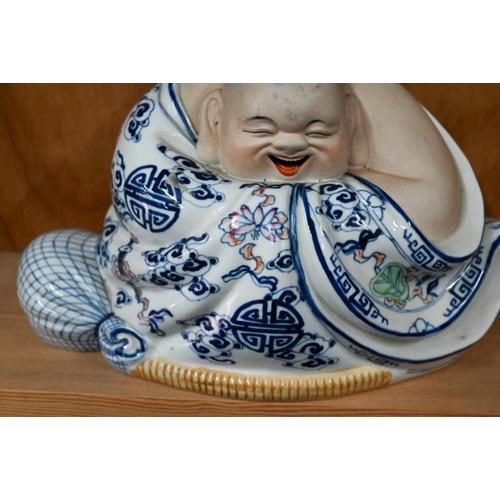 27 - A Chinese part glazed porcelain laughing Buddha, 22 x 37 cm