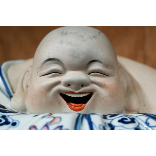 27 - A Chinese part glazed porcelain laughing Buddha, 22 x 37 cm