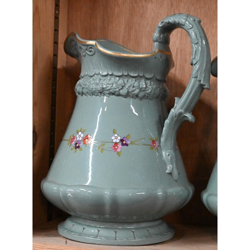 30 - Three Victorian Ridgway green-glazed jugs in differing sizes, with moulded decoration and floral pri... 