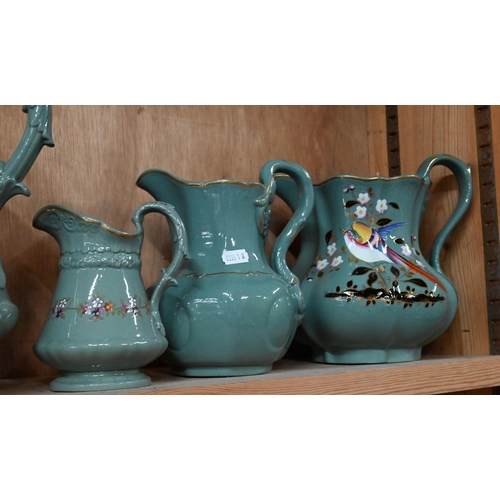 30 - Three Victorian Ridgway green-glazed jugs in differing sizes, with moulded decoration and floral pri... 