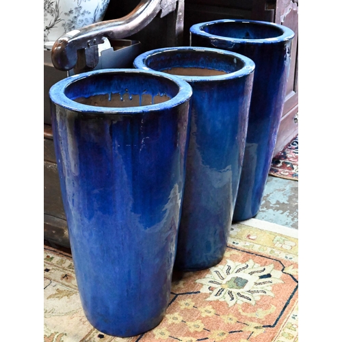 34 - Three large blue-glazed pottery garden planters, 69 cm high (3)