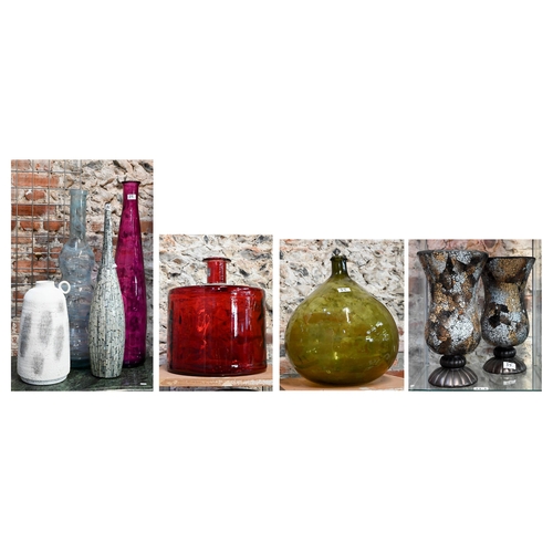 35 - A red glass carboy of cylindrical form, a green glass carboy, two tall glass vases, a ceramic vase w... 