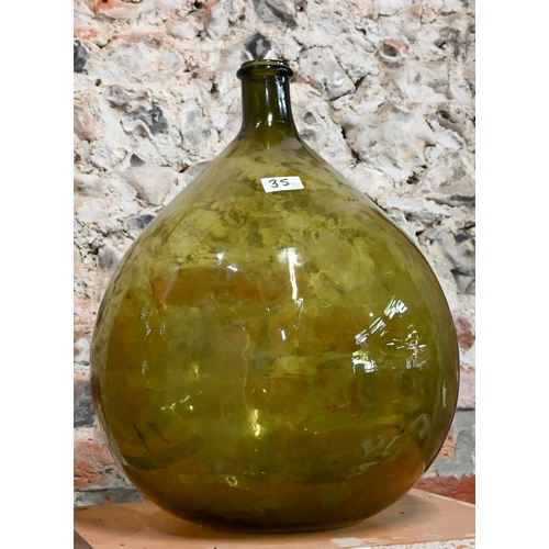 35 - A red glass carboy of cylindrical form, a green glass carboy, two tall glass vases, a ceramic vase w... 