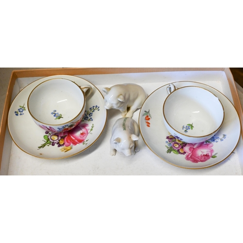 76 - A pair of Meissen floral-painted cups and saucers (one cup with chipped rim), to/w two Belleek pigs ... 