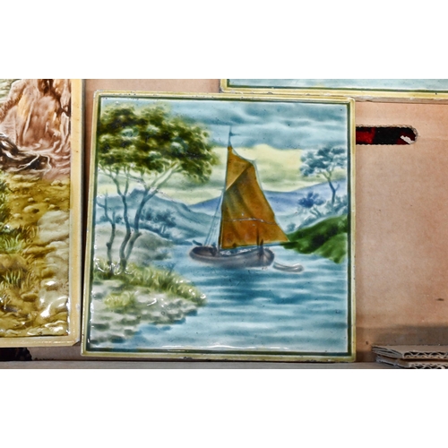 83 - A pair of Edwardian Majolica tiles with Scottish shooting and fishing subjects, 31.5 x 15.5 cm and a... 