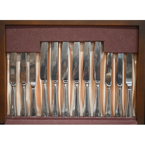 89 - A canteen of stainless steel bead-edge flatware and cutlery