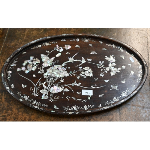 98 - A Chinese oval rosewood tray richly inlaid with mother of pearl flowers, birds and insects, 54 x 34.... 