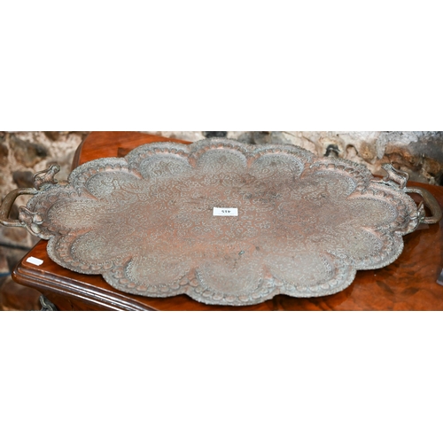 415 - An early 20th century Indian embossed and engraved copper tray with snake and lion handles, 67 cm x ... 