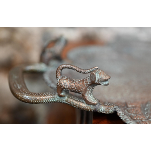 415 - An early 20th century Indian embossed and engraved copper tray with snake and lion handles, 67 cm x ... 