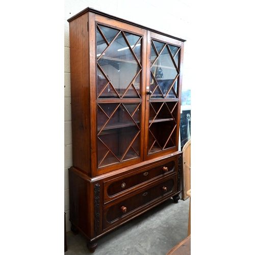 80 - # A 19th century mahogany bookcase on two drawer chest base, the astragal glazed doors enclosing adj... 