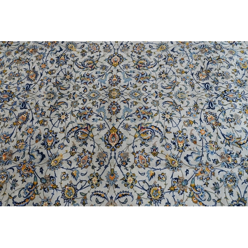 153 - A Persian cream ground Kashan carpet of tradiitonal stylised floral design, with palmette repeating ... 