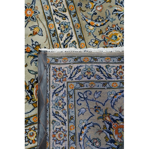 153 - A Persian cream ground Kashan carpet of tradiitonal stylised floral design, with palmette repeating ... 