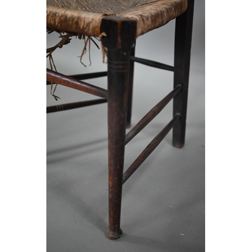 180 - An Arts & Crafts Glasgow School oak high back chair with rush seat, probably by John Ednie (1876... 