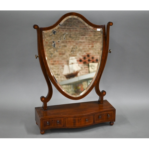 106 - A 19th boxwood inlaid mahogany shield shaped toilet mirror, raised on a serpentine base with three d... 