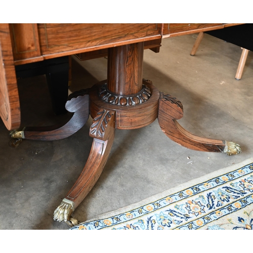 101 - A Regency rosewood sofa table on turned column and quadraform base with brass paw cast casters a/f t... 