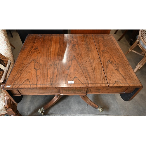 101 - A Regency rosewood sofa table on turned column and quadraform base with brass paw cast casters a/f t... 