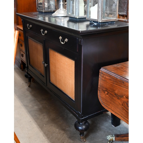 111 - Grange Furniture - a black painted sideboard with three drawers over rattan panelled doors, raised o... 