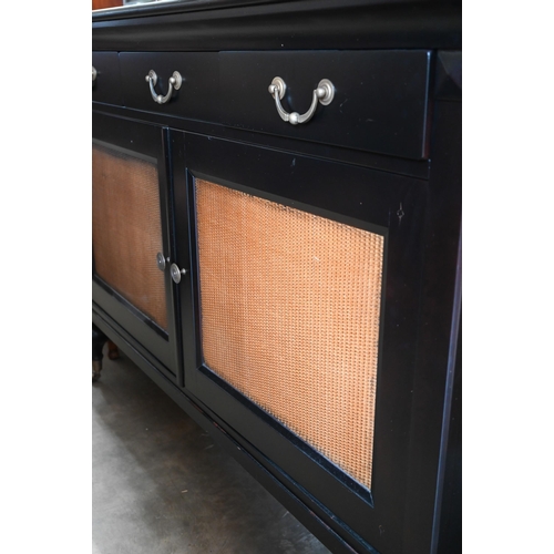 111 - Grange Furniture - a black painted sideboard with three drawers over rattan panelled doors, raised o... 