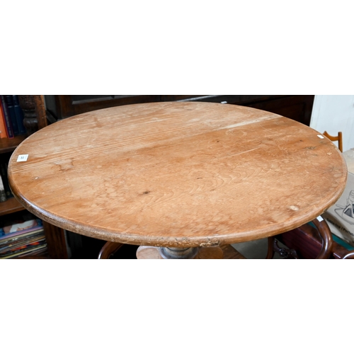 120 - A vintage pine circular table on turned column and triform supports, 80 cm diam x 75 cm high