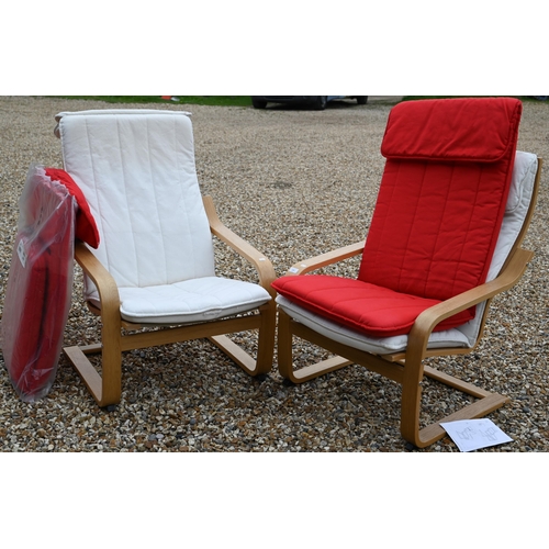 125 - A pair of Ikea 'Poang' light oak finish open armchairs, white cushions plus two extra red cushions