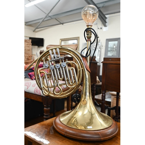 129 - A polished brass French horn table lamp, 70 cm high to/w a walnut and oak mid century low table (2)