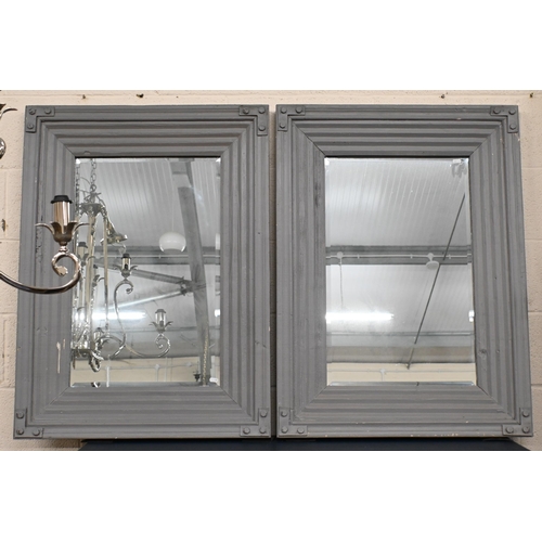 138 - Pair of bevelled rectangular mirrors in moulded grey painted wooden frames, 99 x 73 cm