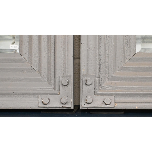 138 - Pair of bevelled rectangular mirrors in moulded grey painted wooden frames, 99 x 73 cm