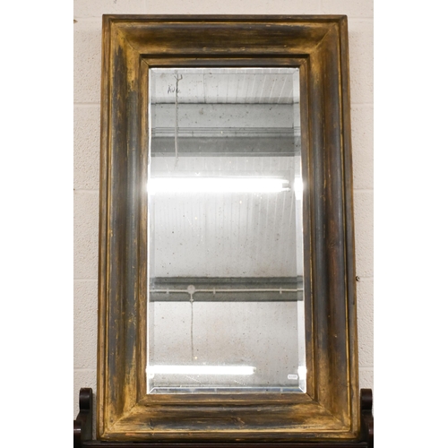 140 - A bevelled rectangular mirror in moulded aged gilt frame, 105 x 62 cm