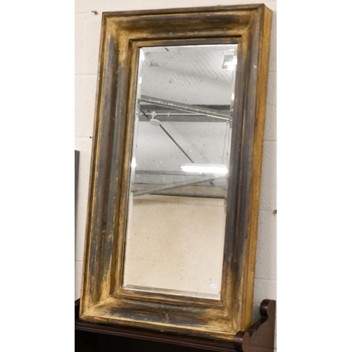 140 - A bevelled rectangular mirror in moulded aged gilt frame, 105 x 62 cm