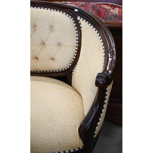 152 - A carved mahogany curved salon settee, yellow button back pilled fabric, 130 x 60 x 100 cm