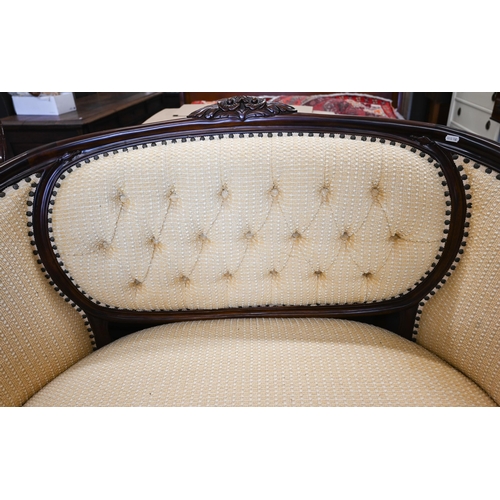 152 - A carved mahogany curved salon settee, yellow button back pilled fabric, 130 x 60 x 100 cm