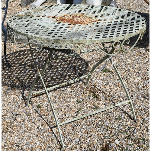 16 - A painted metal French bistro table with lattice top on folding base, 90 cm dia. to/w four black pow... 